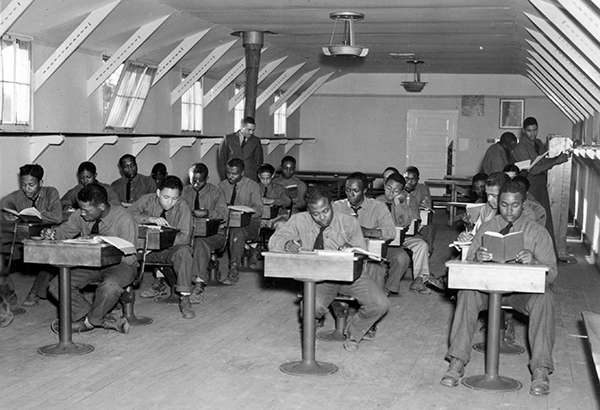 Enrollees at Camp Bitely study for their diplomas as part of their Civilian Conservation Corps service.
