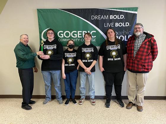 The West Iron County High School Quiz Bowl Team took top honors at the Gogebic Community College annual Spring Invitational Tournament in the Big 16 division. Team members received the first-place trophy from Carl Vaara, retired GCC Math instructor. Pictured are, from left, Vaara, Team Captain Logan McCord, Rachel Fanous, Nick Mattson, Abram Van Lanen and coach, Joel Van Lanen.   (submitted photo)
