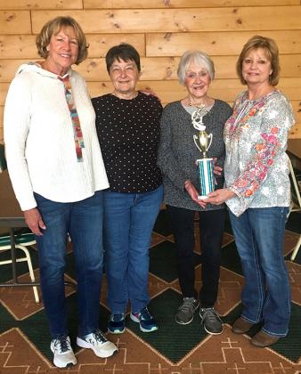 The Amsoil bowling team was presented with a first-place trophy. Pictured, from left, are Cindy Herman, Faith Peterson, Carol Olson, team captain, and Beth Nelson, Crystal Bowlerettes league president.  (submitted photo)