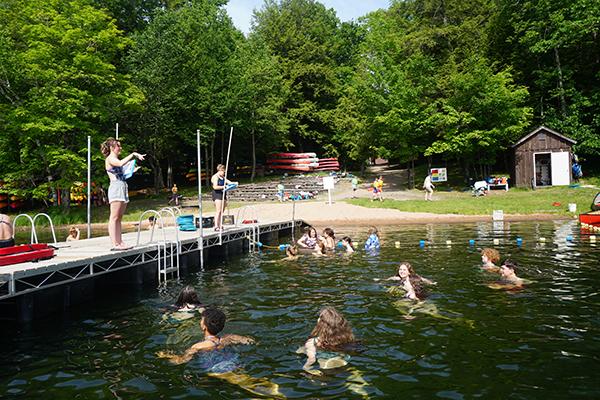 Campers receive instruction as they wade in the refreshing waters of Indian Lake. (submitted photo)
