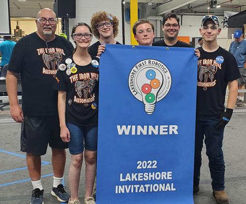 Team 7768 Iron Hill Automatons: Iron County Robotics team, Iron Hill Automatons, proudly display their winning banner after a hard fought race. Pictured, from left, are Van Hill (Coach), Abigail Davis (Driver), Evan Larson (Pit Crew), Cooper Hill (Driver), Jeff Davis (Programming Coach) and Brennon Gursky (Pit Crew). (submitted photo)