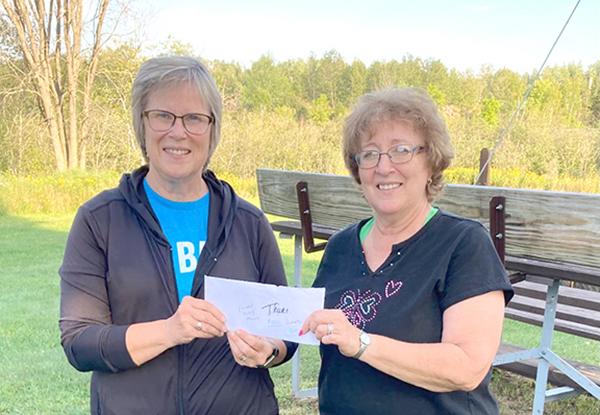 The Co-Ed League donated a portion of the league fees, $540 to the Friends of the Duke of Abruzzi to help their efforts to repair the Duke of Abruzzi building. Dawn Pisoni, Co-Ed League organizer presents league proceeds to Debbie Ketchum, Friends of the Duke of Abruzzi, Treasurer. (submitted photo)