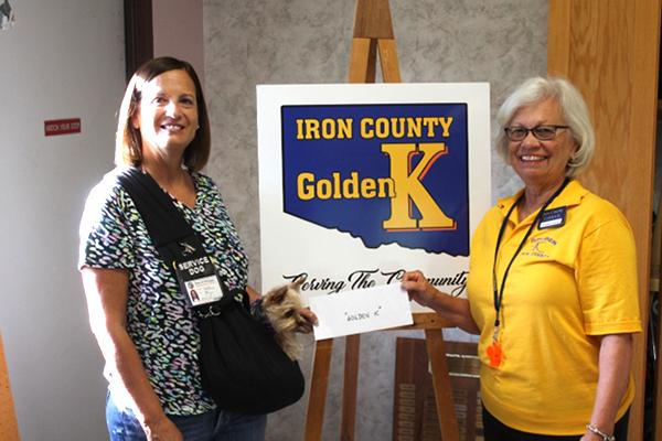 Donna Koski and Nettie, the therapy dog, recently made a donation to the Iron County Golden K Club’s 2022 fundraiser for their Gifts from Santa Project.  Chris Shamion accepted the donation to “kick start” their fund raising. (submitted photo)