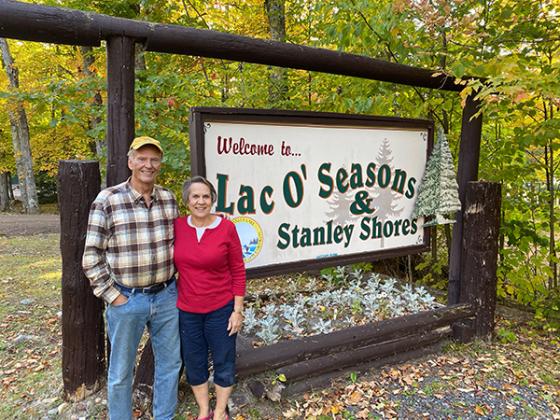 Randy and Nancy Shauwecker stand in fron the Lac o Seasons sign.