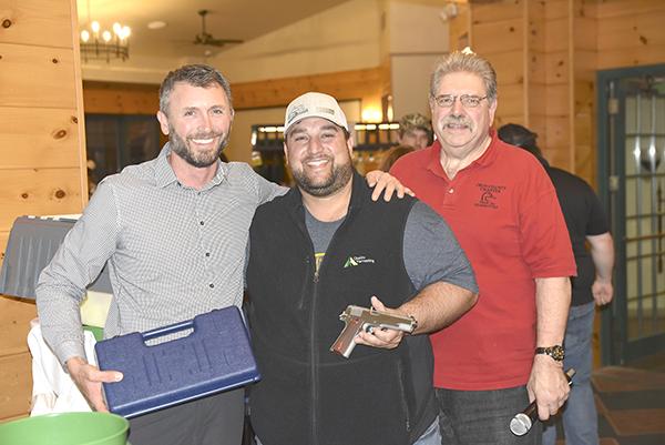The Iron County Ducks Unlimited 42nd banquet was held on Oct. 22 at Young’s Recreational Complex. DU Regional Director Chris Anderson (left) and DU Committee Member Mark Saigh (right) presented the event’s Handgun of the Year to Josh Benson. The banquet offered many raffle prizes including firearms, artwork and DU products.