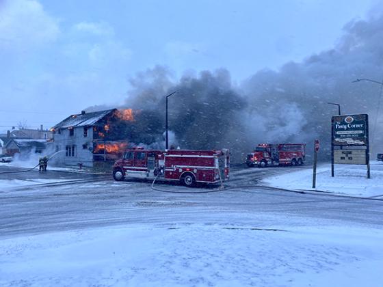 The Caspian-Gaastra Fire Department arrived at the scene of a house fire in Iron River. Two buildings were lost, with minor roof damage to a third. (photo by Jake Wangler) 