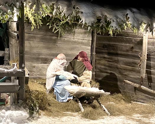 Lakeland Baptist Church hosted its annual Live Nativity Dec. 17 and 18. Destiny Thompson and Paul Starkweather hold baby Jesus as onlookers observe and ponder the true meaning of Christmas . (photos by Kate Collins. More photos on page 2.)