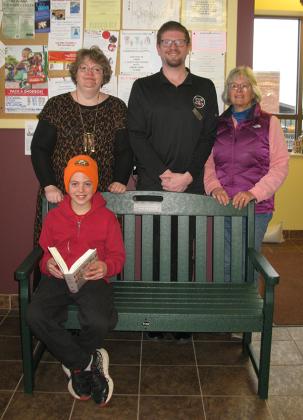 Pictured are back row: Evelyn Gathu (Crystal Falls Community Library Director), Cory Saigh (Director of Services at Crystal Fresh Market), Maureen Elson (Rise Up Indivisible of Iron County). Front row: Browning Kittleson (library patron). (submitted photo)