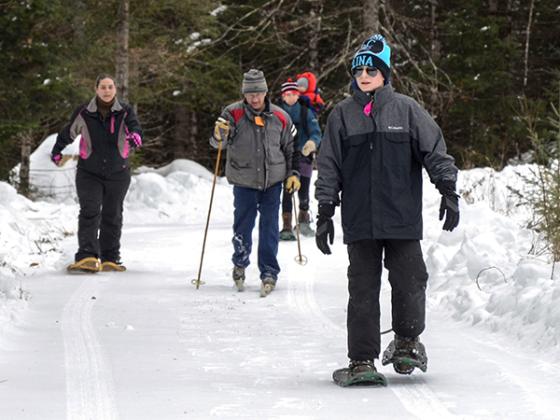 A group of people exercising outdoors during the winter.