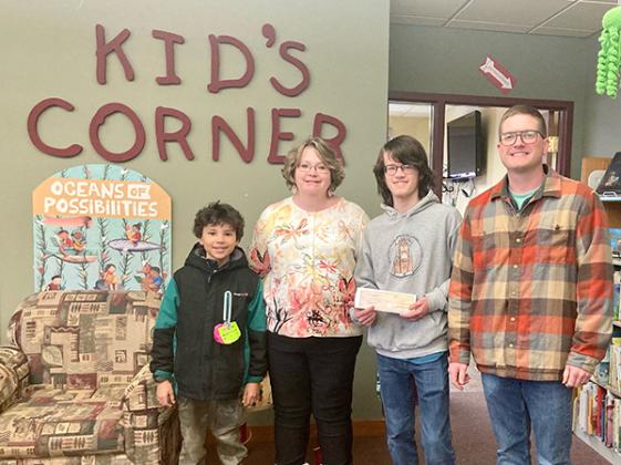 Pictured are, from left, Joah Gathu (a summer reading participant), Evelyn Gathu (Library Director), Jason Anderson (Library Clerk) and Dan Surface (President of the Crystal Falls Area Community Foundation). (submitted photo)