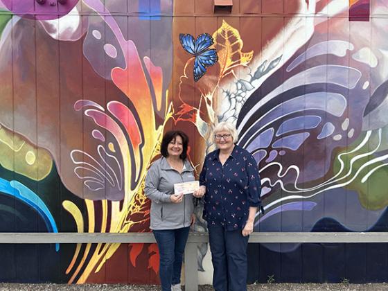Pictured are, from left, Tamara Juul (Director of DACF), presenting the check to Joy Nasi (Art for All Chairperson).