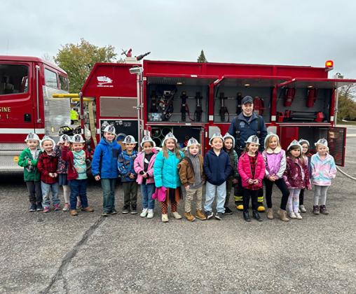 Firefighter, Brandon Maki posed with the kindergarten classes.