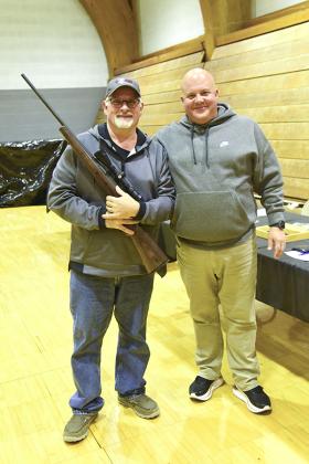 Pictured are, from left, Mark Donati winner of the Savage 243 rifle and Aaron Risberg.