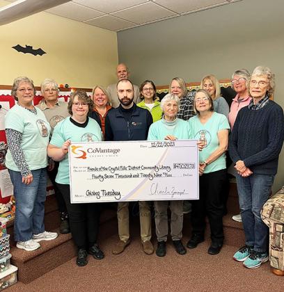 Pictured are, Representatives of Friends of the Crystal Falls District Community Library with CoVantage Branch Manager, Joseph Parker presenting a check totaling $47,029.73 from the CoVantage Cares Giving Tuesday Fundraiser.