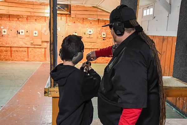 Instructor Greg Scott teaching the students how to load and fire their firearm.