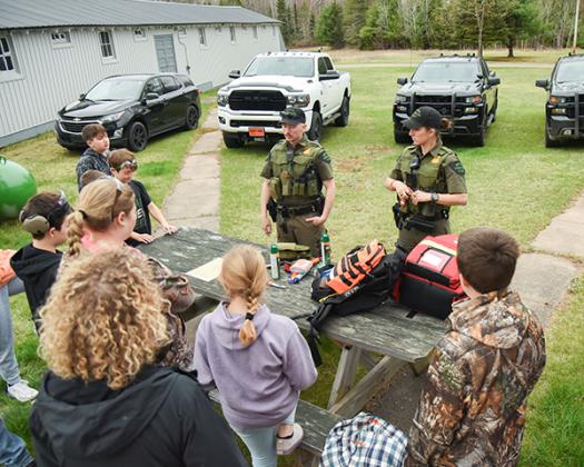 DNR Wardens Anne Viau and Alex VanWagner teaching what and how to pack for survival.