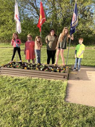 Community Kids 4-H planted flowers at the Caspian Veteran Memorial May 23. The members planted red, white and blue flowers. Doing the planting were Ellianna Olson, Rayne Olson, Chaslynn Olson, Piper Seymour, Riley Shimun and Layla Dobson. Parent helpers were Tammy Seymour, Wendy Otto-Shimun and Danielle Dobson. Supervising was Gary Sabol Mayor of Caspian.  Leader helping were Karen Dobson and Sheri Stauber.  (Submitted photo.)