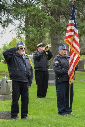 Firing of a volley by members of the Reino Poist 21 firing squad and the playing of the taps at Stambaugh Cemetary.